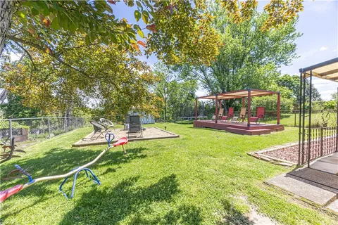 a view of a house with backyard porch and sitting area