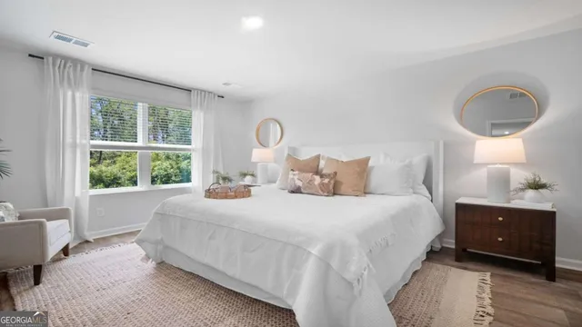 a bedroom with a bed and a large window