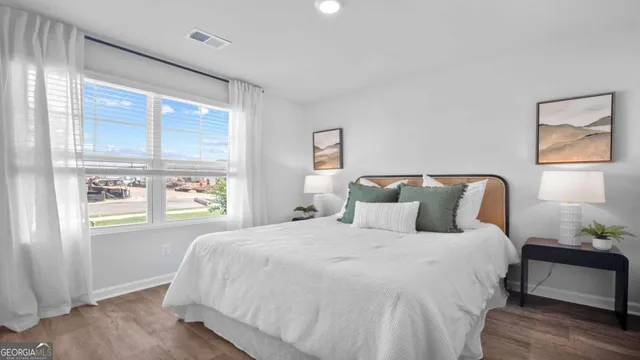 a bedroom with a bed and window