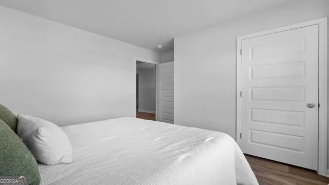 a bedroom with a bed and a rug