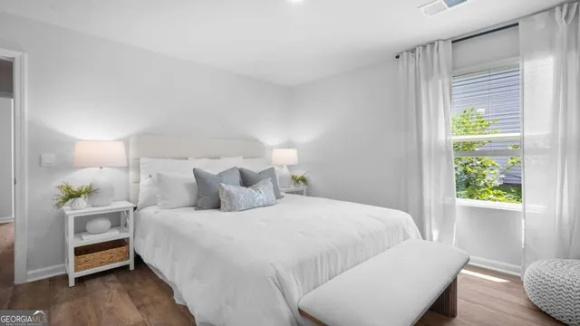 a bedroom with a bed and a window