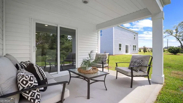 a outdoor living room with furniture and a large window