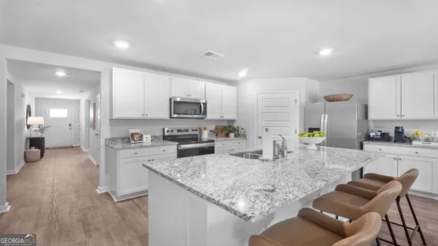 a kitchen with refrigerator stove microwave and cabinets