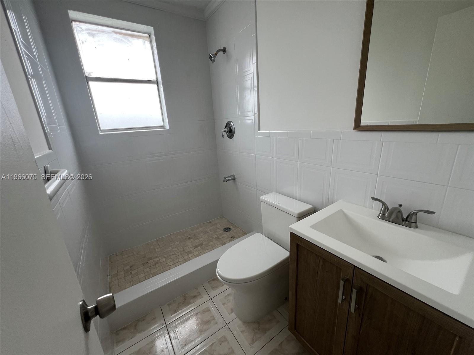 1104 West 44th Street, Unit 87 Hialeah, FL 33012 - Photo 12 of 13 a bathroom with a sink toilet and window