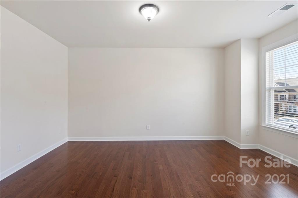 4331 Oxford Mill Road Waxhaw, NC 28173 - Photo 3 of 48 an empty room with wooden floor and windows