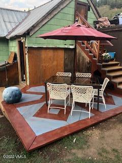 383 Pine Street Red Cliff, CO 81649 - Photo 25 of 31 a view of a patio with table and chairs under an umbrella
