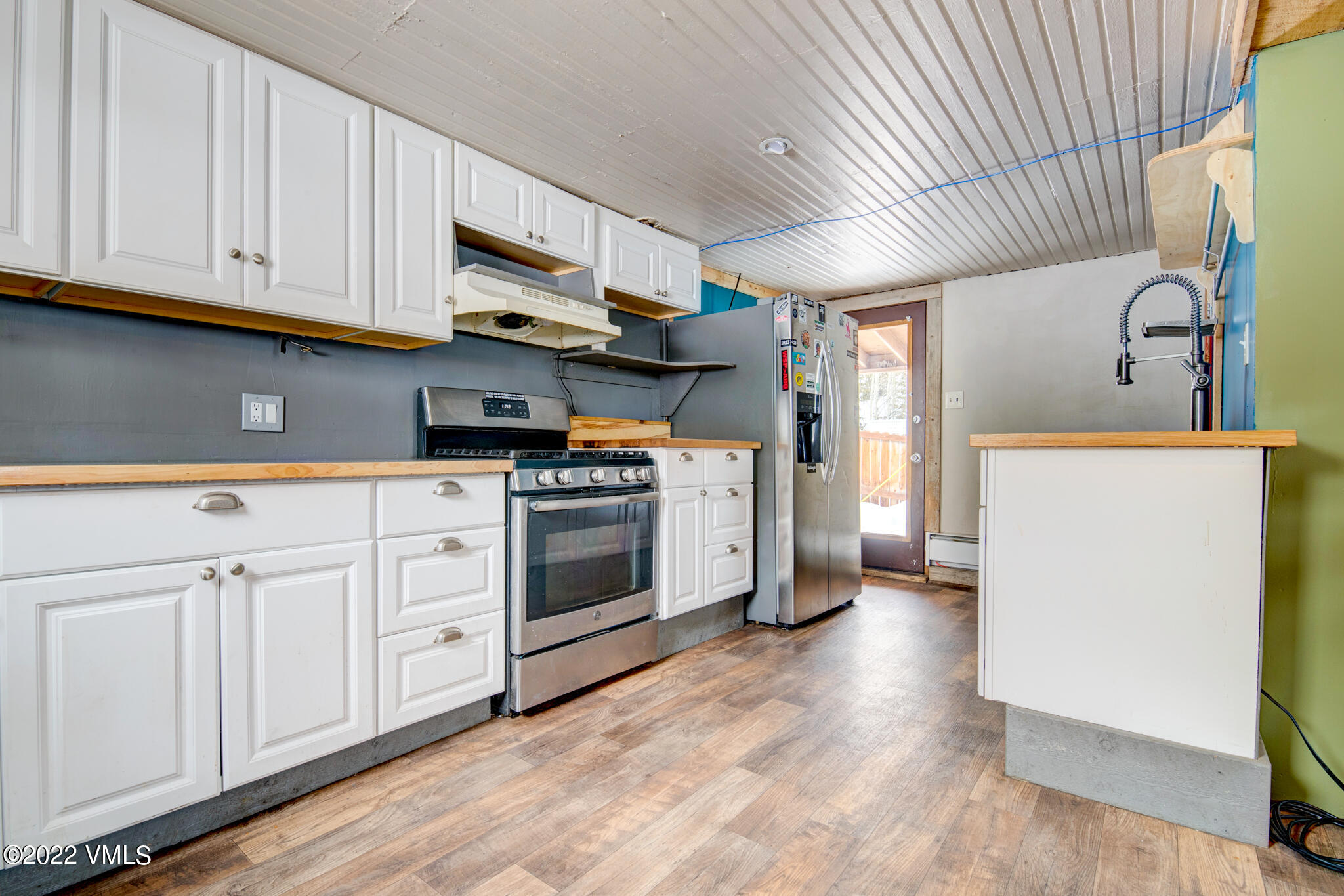 383 Pine Street Red Cliff, CO 81649 - Photo 6 of 31 a kitchen with granite countertop white cabinets and white appliances