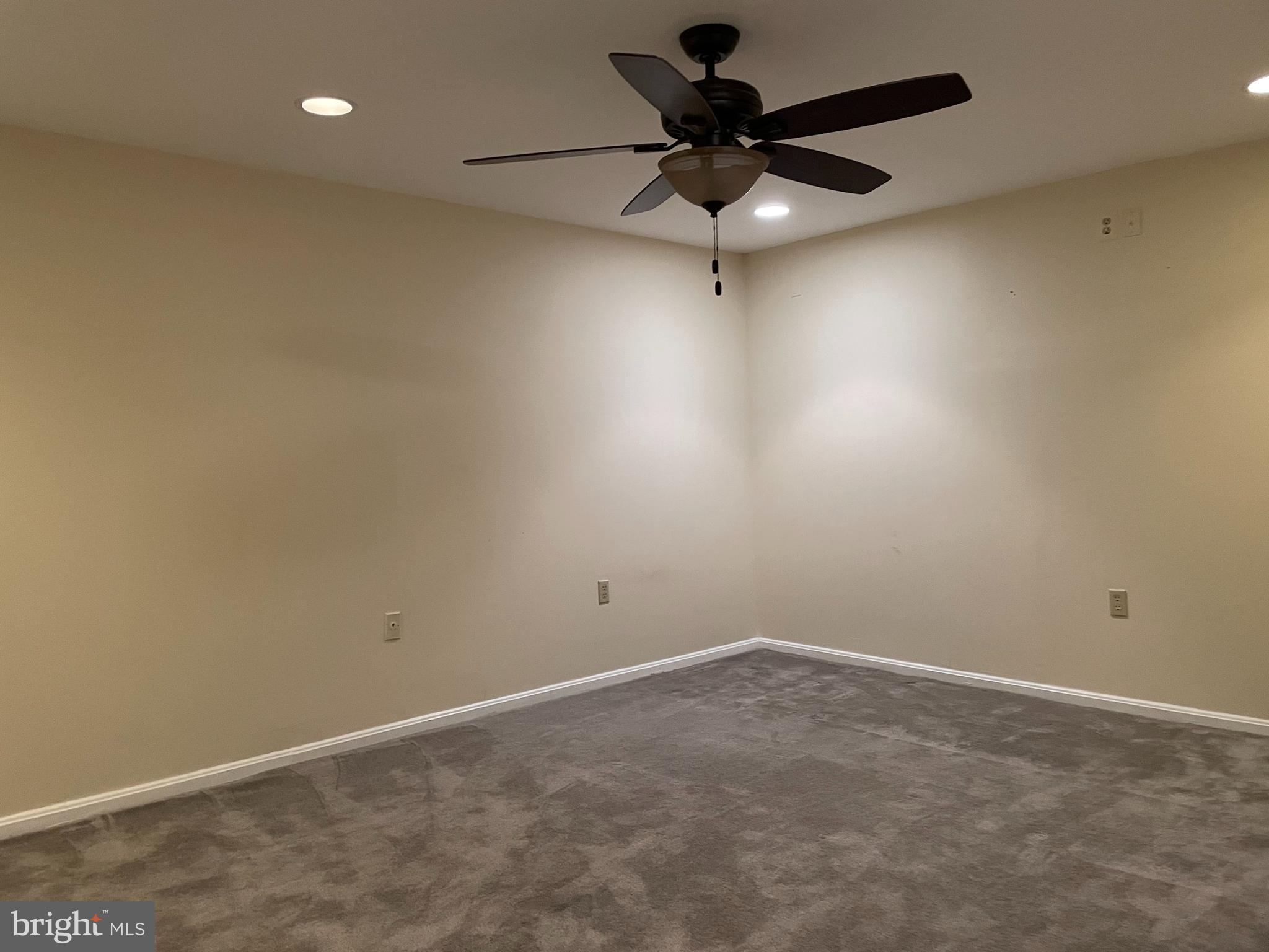 12405 Gooderham Way Gaithersburg, MD 20878 - Photo 23 of 31 an empty room with a ceiling fan and window