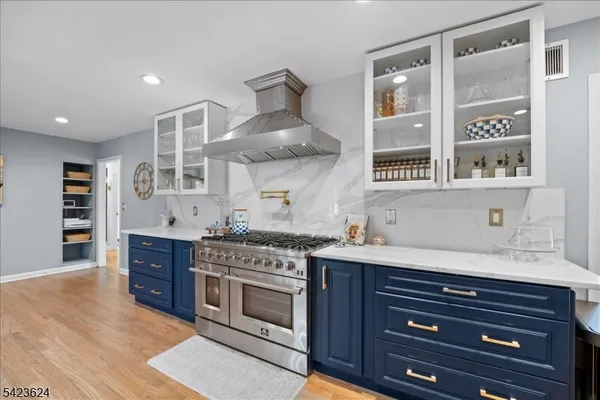 a kitchen with stainless steel appliances granite countertop a stove and a sink