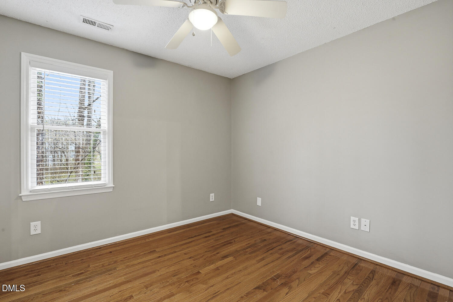 2717 Rockbridge Court Raleigh, NC 27604 - Photo 9 of 16 an empty room with wooden floor and windows