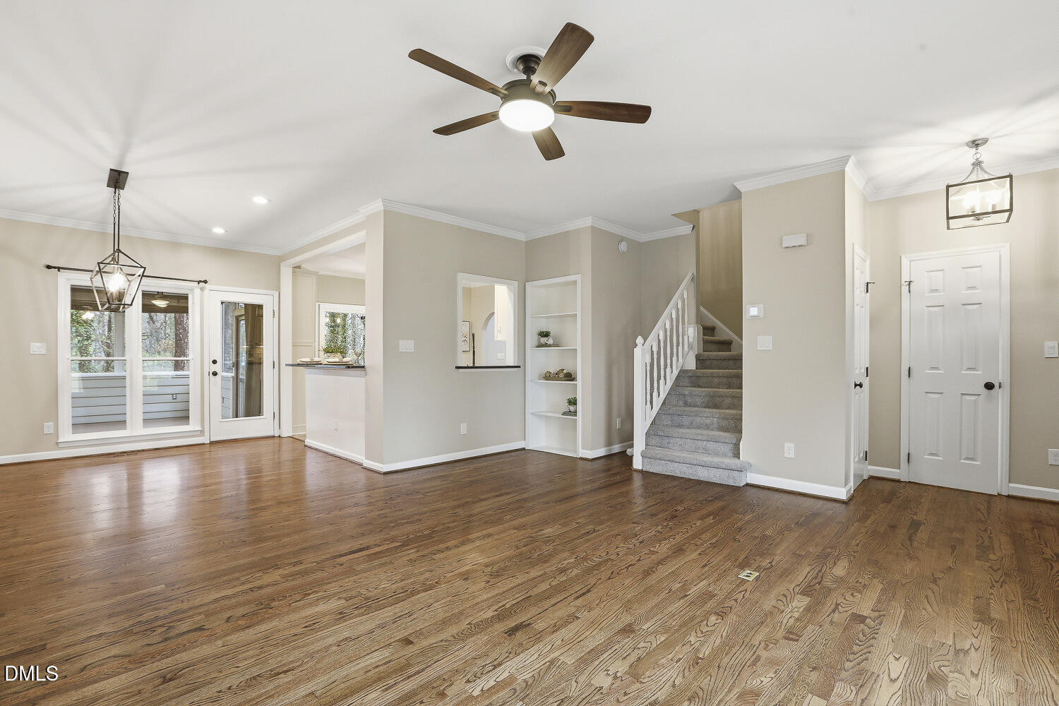 2717 Rockbridge Court Raleigh, NC 27604 - Photo 3 of 16 a view of an empty room with wooden floor and a ceiling fan