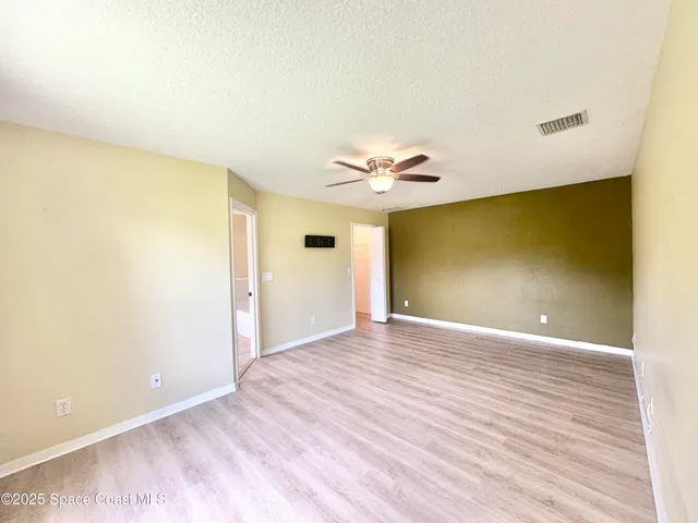 a bathroom with a granite countertop sink a mirror and a bathtub