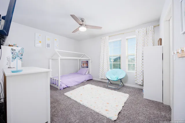 a bedroom with furniture and a window