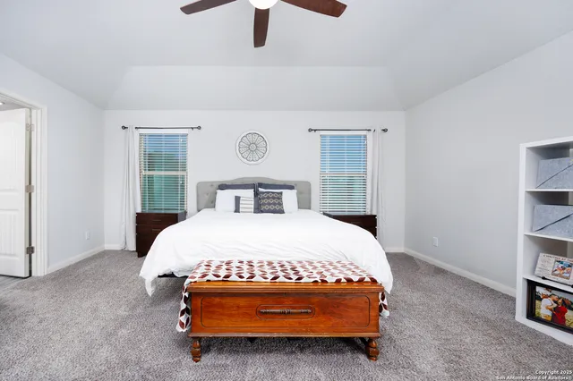 a bedroom with a bed and a book shelf
