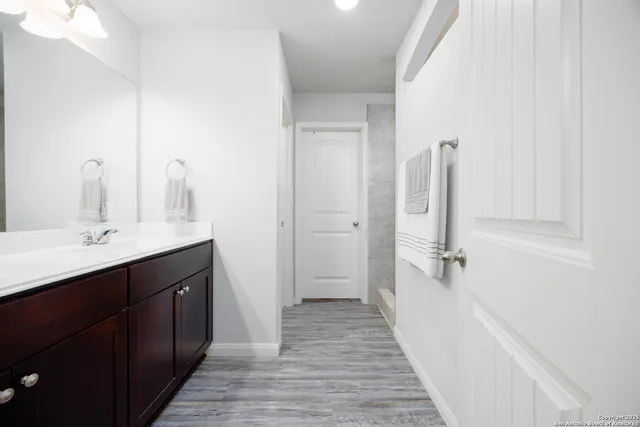a bathroom with a double vanity sink a and a mirror