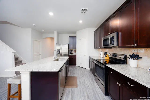 a kitchen with counter space cabinets and appliances