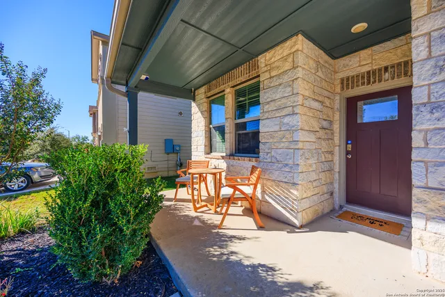 a view of a patio with table and chairs and potted plants