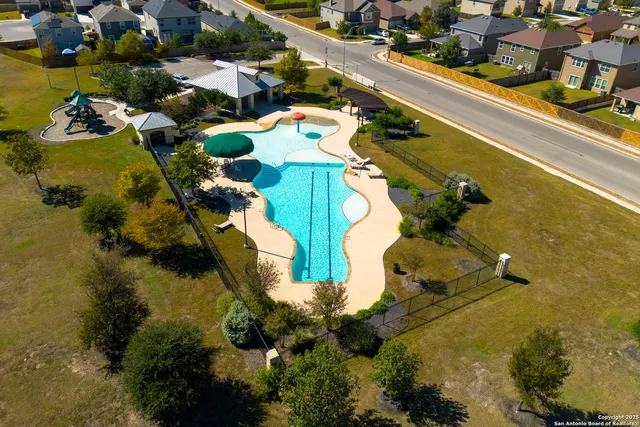an aerial view of a house with yard swimming pool and outdoor seating