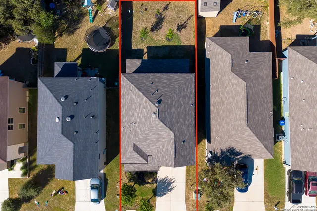 an aerial view of residential houses with outdoor space