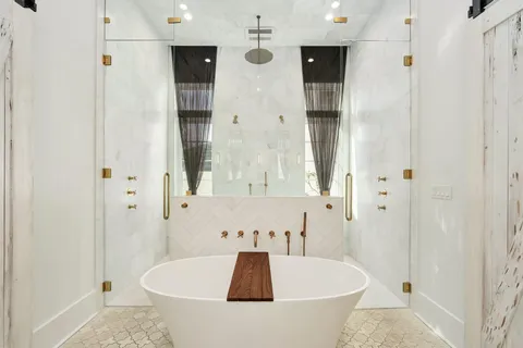 a spacious bathroom with a double vanity sink and a mirror