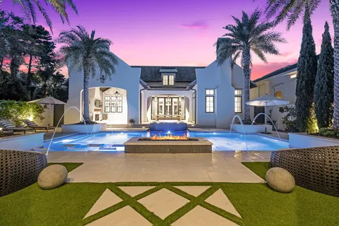 a view of a house with swimming pool and sitting area