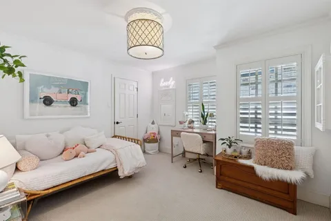 a spacious bedroom with a bed and a large window