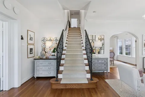 a view of entryway and hall with wooden floor