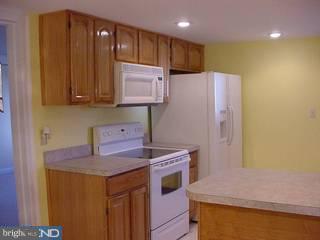 39 Magnolia Road Pemberton, NJ 08068 - Photo 2 of 6 a kitchen that has a sink and a stove with wooden floor