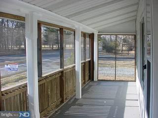 39 Magnolia Road Pemberton, NJ 08068 - Photo 5 of 6 a view of a hallway with wooden floor and windows