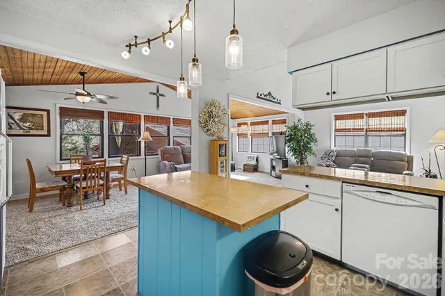 a kitchen with a table chairs and white cabinets
