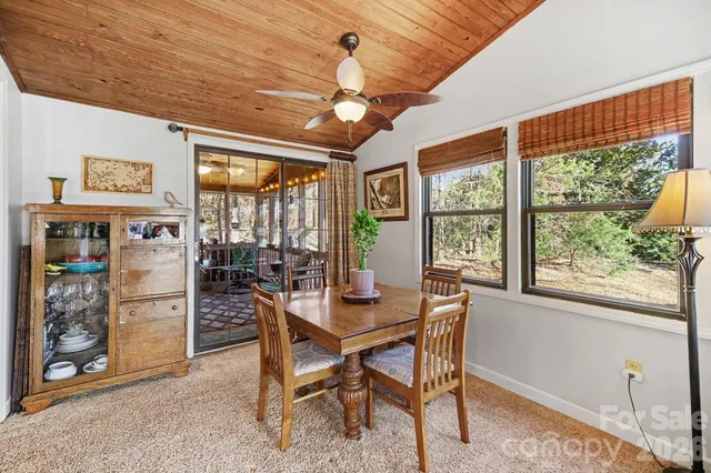 a dining room with furniture a chandelier and window