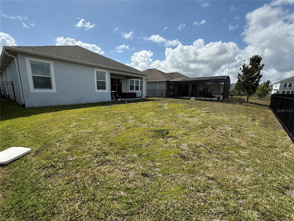 2926 Wordsmith Road Kissimmee, FL 34746 - Photo 41 of 42 a view of a house with a backyard and a patio