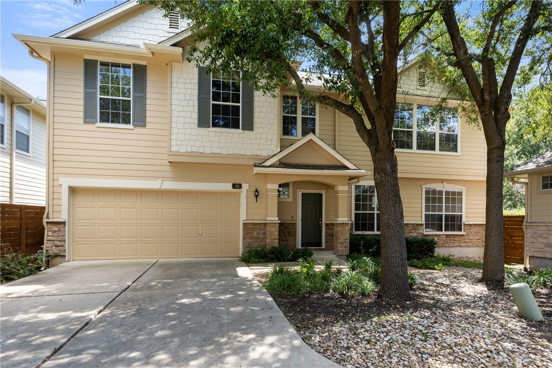 a view of a white house with a yard and large tree