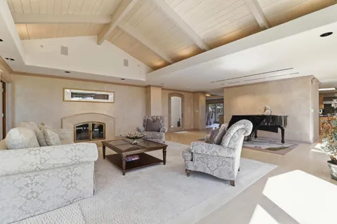 a living room with furniture fireplace and a fireplace