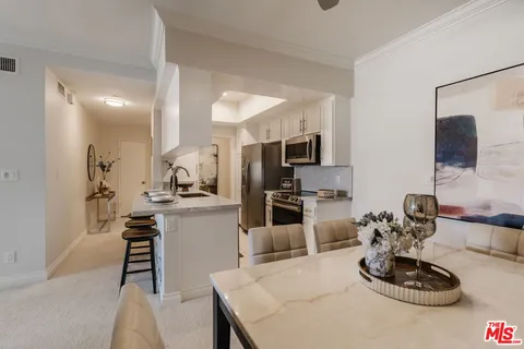 a kitchen with a table and chairs in it
