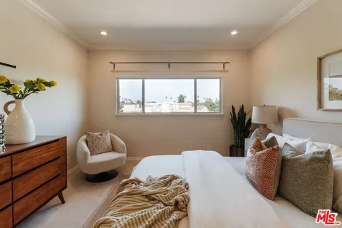 a bedroom with furniture and a window