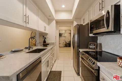 a kitchen with stainless steel appliances a sink a stove and a refrigerator