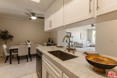 a kitchen with a sink a table and chairs