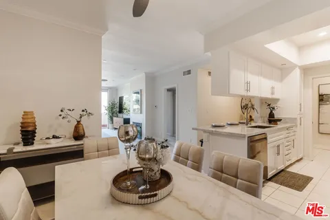 a living room with furniture a rug and white walls