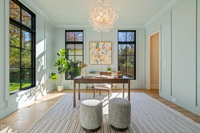 a view of hallway with furniture and floor to ceiling window