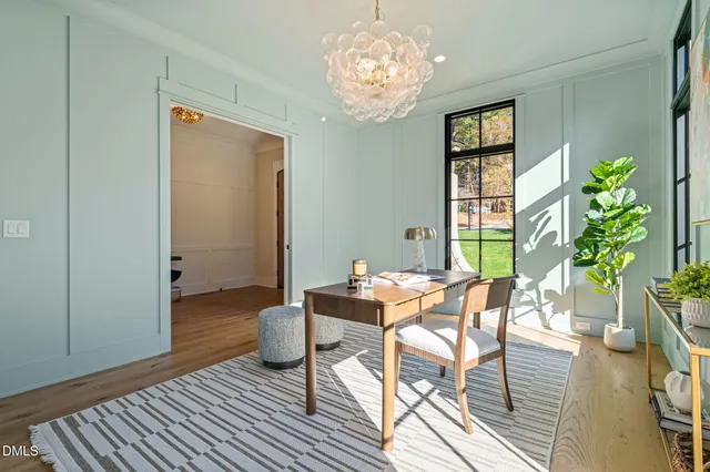 a dining room with furniture a chandelier and wooden floor