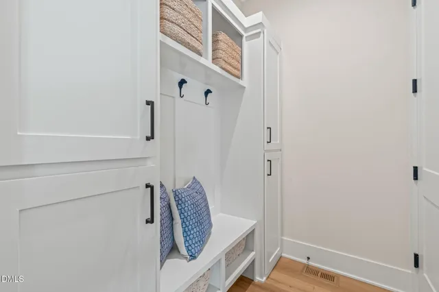 a kitchen with a dining table chairs stainless steel appliances and cabinets