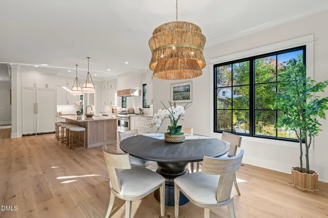 a spacious bedroom with a bed a couch and large window