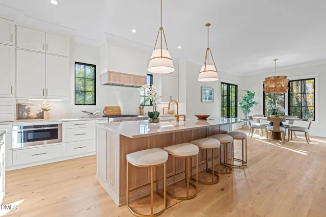 a bathroom with a double vanity sink a mirror a bathtub and shower
