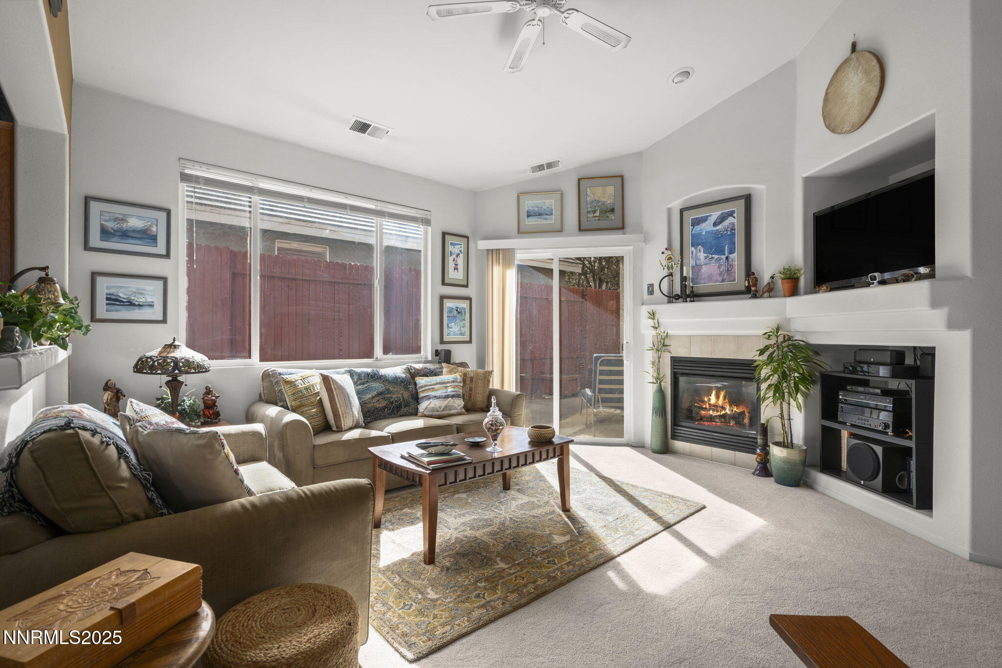 9721 Ripple Way Reno, NV 89521 - Photo 2 of 22 a living room with furniture a fireplace and a flat screen tv