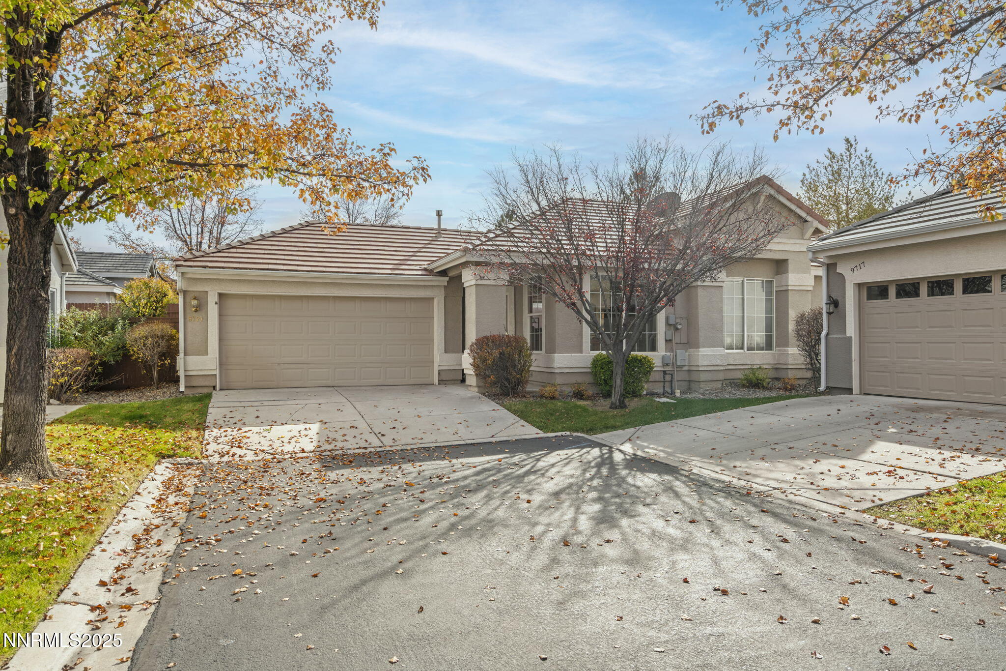 9721 Ripple Way Reno, NV 89521 - Photo 21 of 22 a front view of a house with a yard and garage