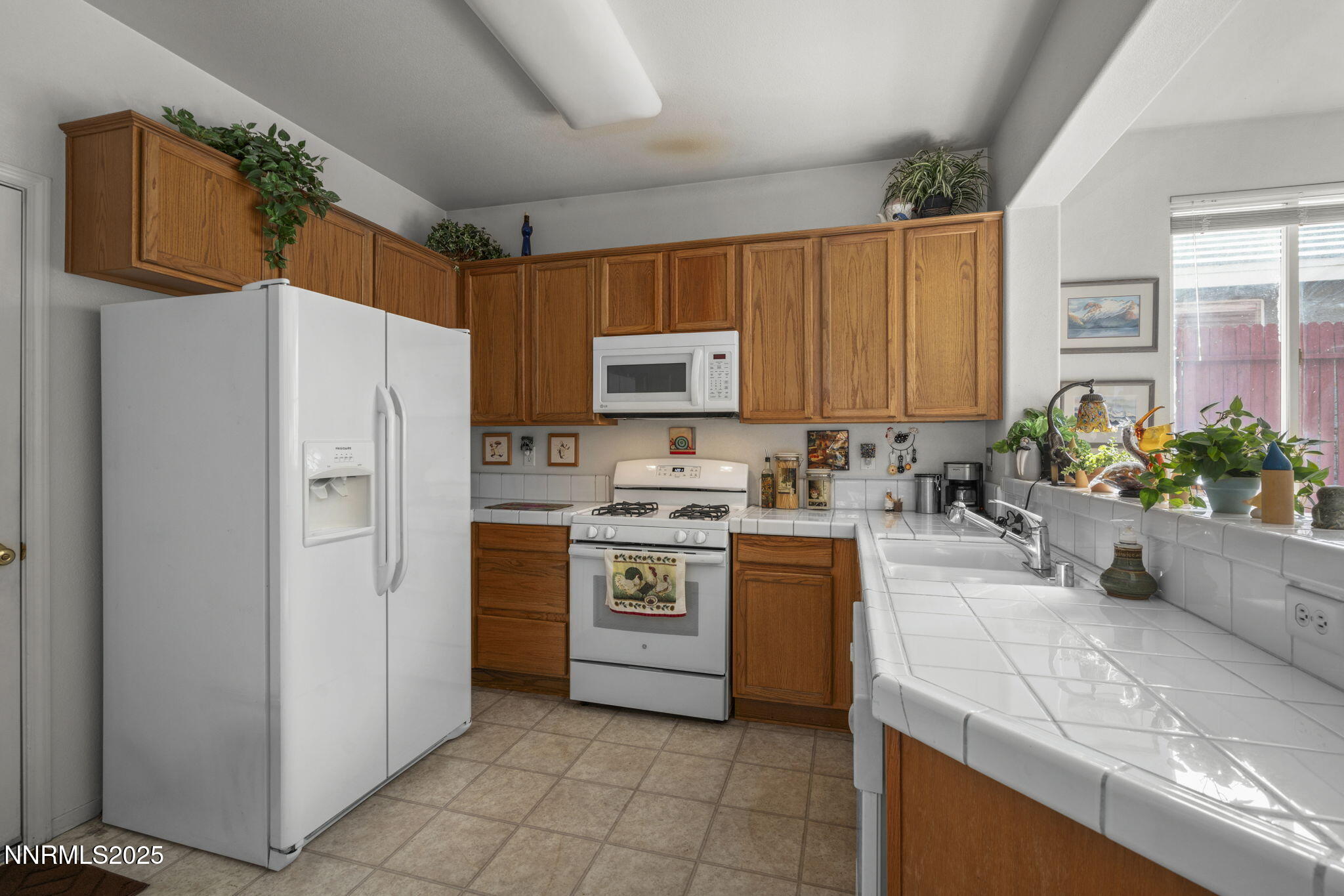 9721 Ripple Way Reno, NV 89521 - Photo 5 of 22 a kitchen with stainless steel appliances granite countertop a refrigerator sink and stove