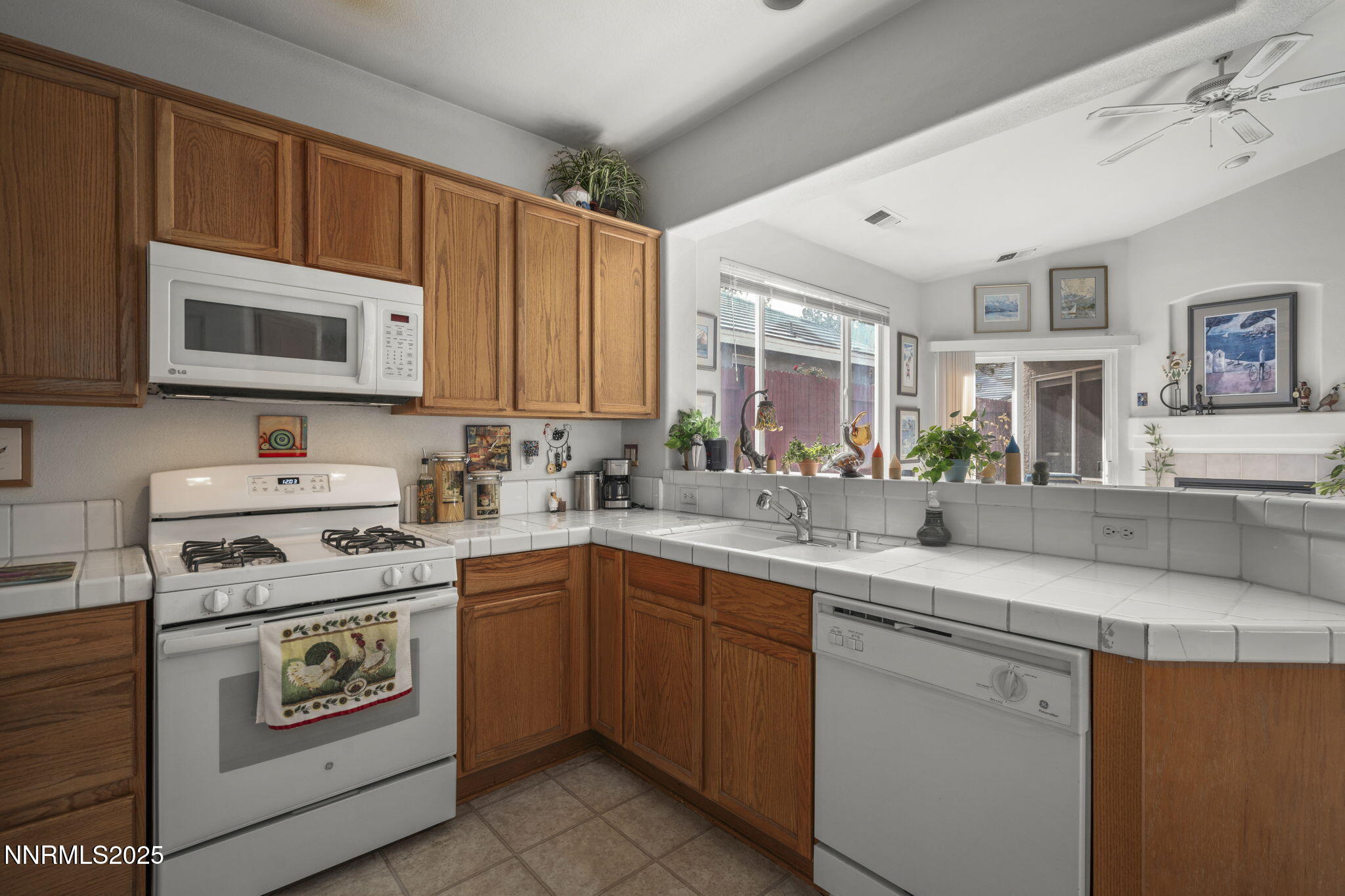 9721 Ripple Way Reno, NV 89521 - Photo 6 of 22 a kitchen with stainless steel appliances granite countertop a sink and stove top oven