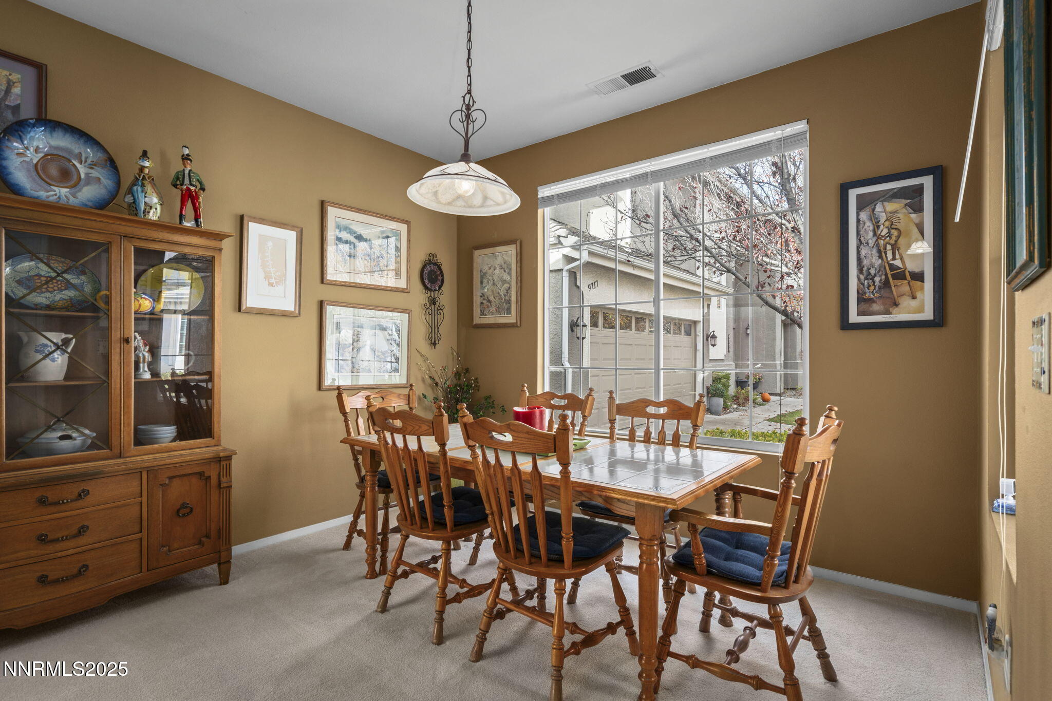 9721 Ripple Way Reno, NV 89521 - Photo 8 of 22 a view of a dining room with furniture large windows and a chandelier