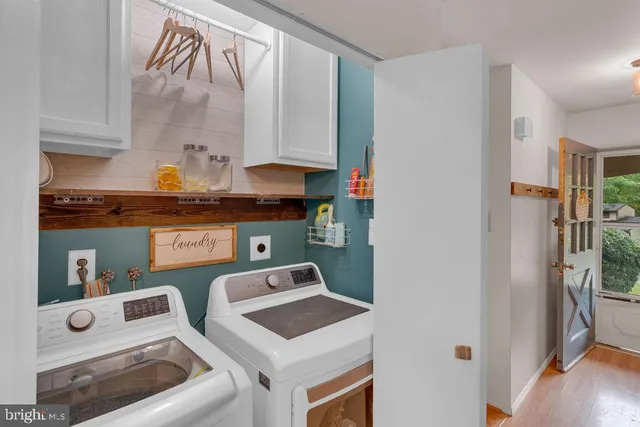 a utility room with multiple dryer and washer